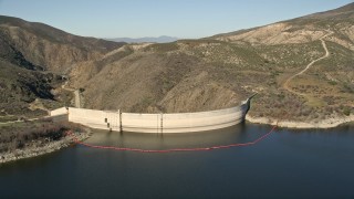 AX0014_028 - 5K aerial stock footage fly low over Lake Hemet and approach Hemet Dam, California