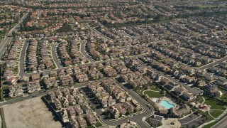 AX0014_044E - 5K aerial stock footage approach residential neighborhoods and tilt to homes, Temecula, California