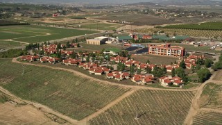 5K aerial stock footage orbiting a resort among vineyards, Temecula, California Aerial Stock Footage | AX0014_064