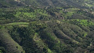 5K aerial stock footage of flying over hills toward farmland, Fallbrook, California Aerial Stock Footage | AX0015_015