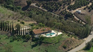 AX0015_021 - 5K aerial stock footage of orbiting hilltop house, Fallbrook, California