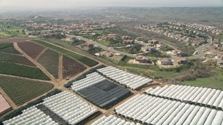 5K aerial stock footage fly over farmland near residential neighborhoods, Oceanside, California Aerial Stock Footage | AX0015_039