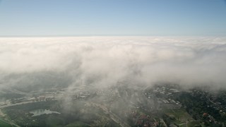 5K aerial stock footage video fly over a large break in the clouds covering Oceanside, California Aerial Stock Footage | AX0015_049