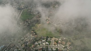 5K aerial stock footage of a bird's eye of residential neighborhoods through clouds, Oceanside, California Aerial Stock Footage | AX0015_052