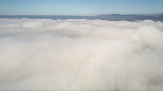 5K aerial stock footage fly over a thick cover of white clouds beneath blue sky, California Aerial Stock Footage | AX0015_053