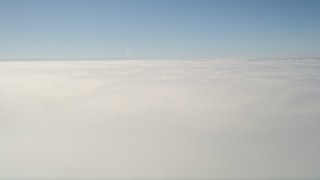 5K aerial stock footage flyby and pan across thick cloud cover beneath blue skies, California Aerial Stock Footage | AX0016_001