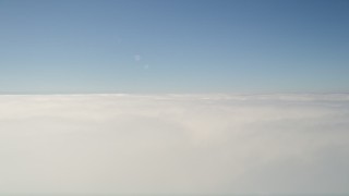 5K aerial stock footage pan across dense cloud cover with blue skies overhead, California Aerial Stock Footage | AX0016_003