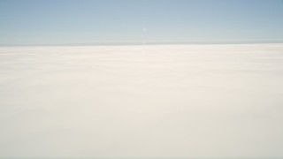 5K aerial stock footage pan across thick cloud cover with blue sky above, California Aerial Stock Footage | AX0016_004