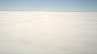 5K aerial stock footage of a reverse view of the edge of the clouds, then pan across the cloud layer, Oceanside, California Aerial Stock Footage | AX0016_008