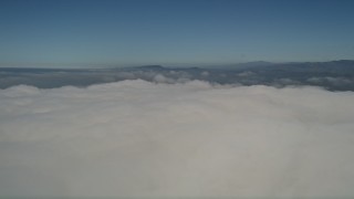 5K aerial stock footage of panning across the top of the cloud layer to reveal the edge, California Aerial Stock Footage | AX0016_012