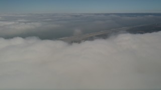 5K aerial stock footage tilt from dense cloud layer to reveal the coastline, Camp Pendleton, California Aerial Stock Footage | AX0016_014