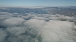 5K aerial stock footage fly over clouds breaking up over the coast near Camp Pendleton, California Aerial Stock Footage | AX0016_019E