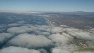 5K aerial stock footage fly over clouds breaking up along the coast, Camp Pendleton, California Aerial Stock Footage | AX0016_021