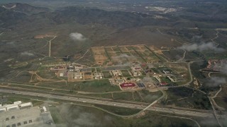 5K aerial stock footage flyby clouds hanging over Camp Pendleton South buildings, California Aerial Stock Footage | AX0016_024