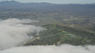 5K aerial stock footage of clouds by a military base training camp, Camp Pendleton, California Aerial Stock Footage | AX0016_036