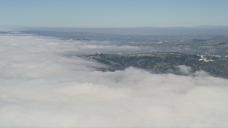 5K aerial stock footage fly over clouds to approach a group of hillside homes, San Clemente, California Aerial Stock Footage | AX0016_037