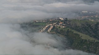 5K aerial stock footage approach hillside suburban homes bordered by clouds, San Clemente, California Aerial Stock Footage | AX0016_038