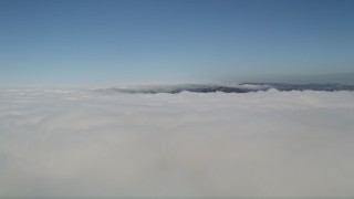 5K aerial stock footage fly over and pan across a cloud layer with blue skies above, Laguna Niguel, California Aerial Stock Footage | AX0016_048