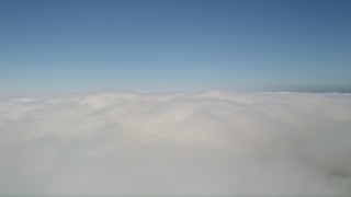 5K aerial stock footage pan across a layer of clouds with blue skies overhead, California Aerial Stock Footage | AX0016_051