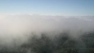 5K aerial stock footage of flying by the edge of a cloud bank, Laguna Beach, California Aerial Stock Footage | AX0016_065