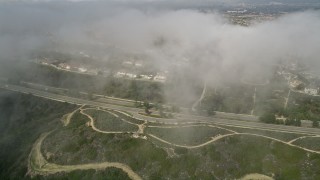 5K aerial stock footage approach residential roads near suburban homes and beneath clouds; Newport Beach, California Aerial Stock Footage | AX0016_072