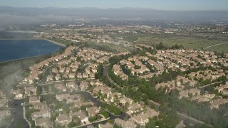 5K aerial stock footage fly over residential neighborhood beside the San Joaquin Reservoir, Newport Beach, California Aerial Stock Footage | AX0016_073