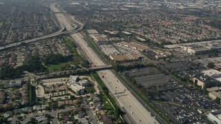 5K aerial stock footage tilt to a bird's eye view of the Trinity Broadcasting Network building beside I-405 with light traffic, Costa Mesa, California Aerial Stock Footage | AX0016_087