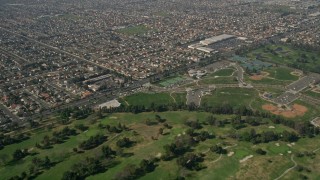 5K aerial stock footage fly over Mile Square Golf Course, to and approach residential neighborhoods, Fountain Valley, California Aerial Stock Footage | AX0016_094