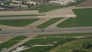 5K aerial stock footage of tracking a helicopter lifting off from Los Alamitos Army Airfield, California Aerial Stock Footage | AX0016_096