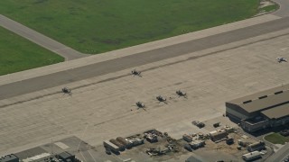 5K aerial stock footage flyby parked military helicopters at Los Alamitos Army Airfield, California Aerial Stock Footage | AX0016_099