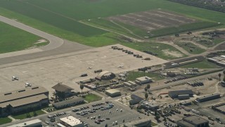 AX0016_100 - 5K aerial stock footage of aircraft parked at Los Alamitos Army Airfield, California