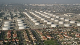 5K aerial stock footage approach residential neighborhood and storage tanks, Carson, California Aerial Stock Footage | AX0017_008E