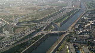 5K aerial stock footage fly over heavy interstate traffic along a river, Carson, California Aerial Stock Footage | AX0017_010