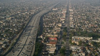 5K aerial stock footage of following Broadway and Interstate 110 past residential neighborhoods, South Central Los Angeles Aerial Stock Footage | AX0017_035