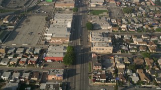 5K aerial stock footage of following a city street past apartment buildings, South Central Los Angeles Aerial Stock Footage | AX0017_036