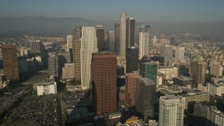 AX0017_071E - 5K aerial stock footage of orbiting Ritz Carlton revealing skyscrapers, Downtown Los Angeles