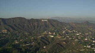 AX0017_086 - 5K aerial stock footage of homes and apartment buildings in the hills, reveal Hollywood Sign, Hollywood, California