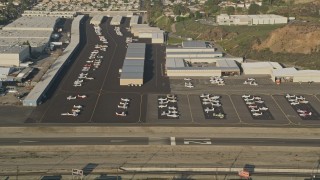 5K aerial stock footage of Whiteman Airport, tilt to parked airplanes, Pacoima, California, sunset Aerial Stock Footage | AX0017_118