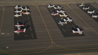 5K aerial stock footage of airplanes on the tarmac at Whiteman Airport, Pacoima, California, sunset Aerial Stock Footage | AX0017_119