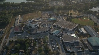 AX0018_026 - 5K aerial stock footage of approaching a high school in Orlando, Florida at sunrise