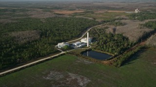 5K aerial stock footage of large water tanks at an Orlando farm at sunrise, Florida Aerial Stock Footage | AX0018_032