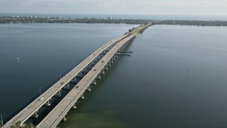 AX0018_065E - 5K aerial stock footage of light traffic on Melbourne Causeway spanning Indian River, Florida