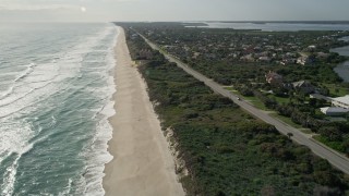 AX0018_079E - 5K aerial stock footage fly over sandy shore of Melbourne Beach in Florida