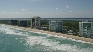 AX0019_006 - 5K aerial stock footage of passing apartment buildings in Jensen Beach, Florida 