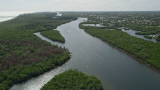 AX0019_008E - 5K aerial stock footage approach and fly over boats on the Indian River through Hobe Sound, Florida