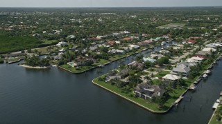 5K aerial stock footage of waterfront homes on canals in Hobe Sound, Florida Aerial Stock Footage | AX0019_011