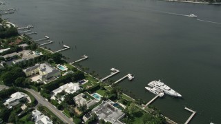 AX0019_057 - 5K aerial stock footage of waterfront property with yacht docked on the lake in Palm Beach, Florida