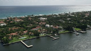 AX0019_067 - 5K aerial stock footage flyby lakefront mansions with docks in Palm Beach, Florida