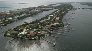 5K aerial stock footage approach lakefront mansions on a small island on Lake Worth in Palm Beach, Florida Aerial Stock Footage | AX0019_073E