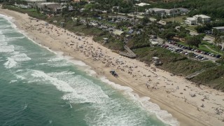 5K aerial stock footage of approaching a beach with sunbathers in Boynton Beach, Florida Aerial Stock Footage | AX0019_085